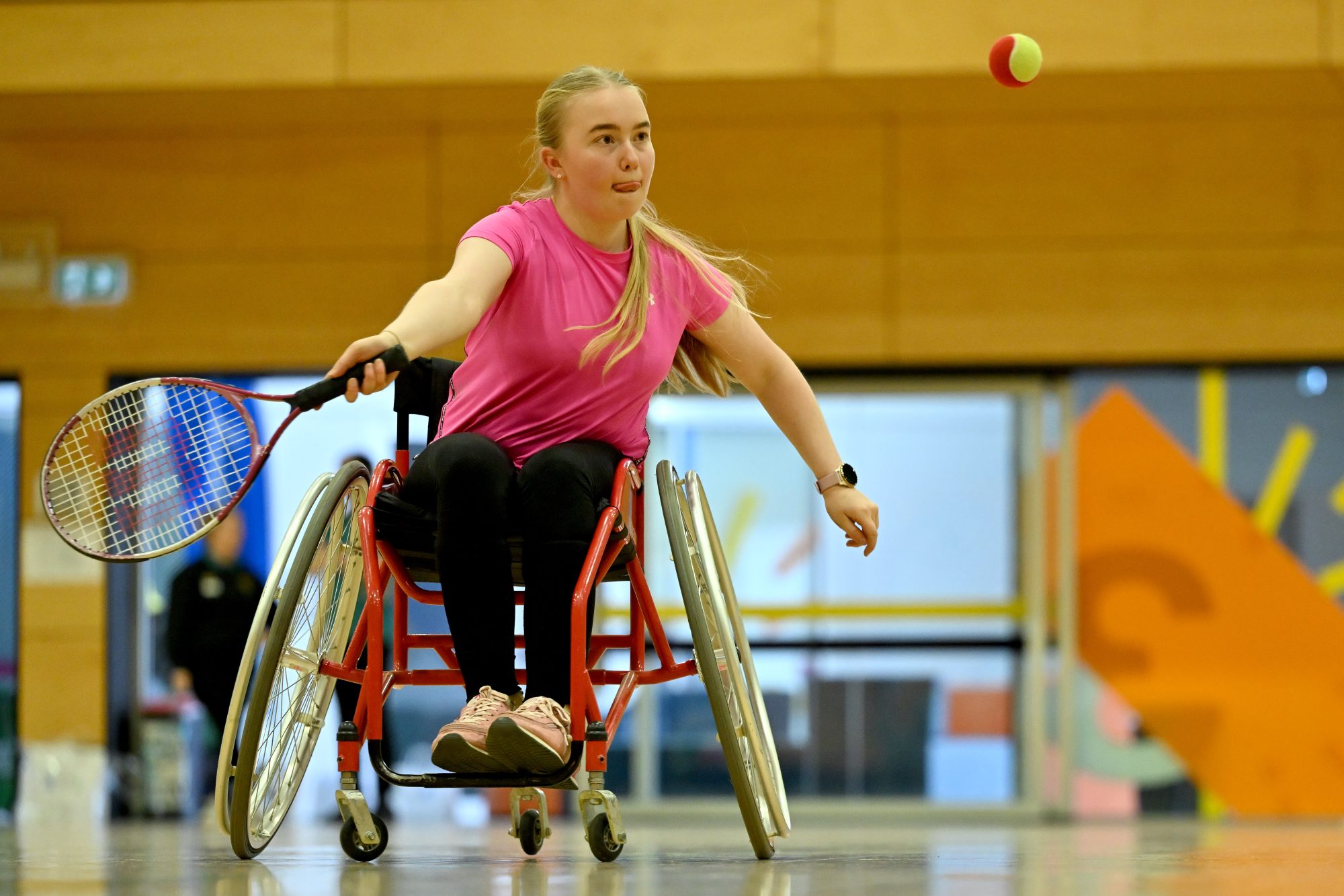 http://A%20girl%20in%20a%20pink%20t-shirt%20playing%20wheelchair%20tennis